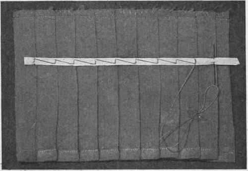 Fig. 232. Method of tacking plaits, to preserve their shape.