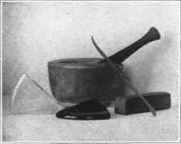 Fig. 148. Mortar and pestle, pieces of enamel, spatula, and carborundum stone.