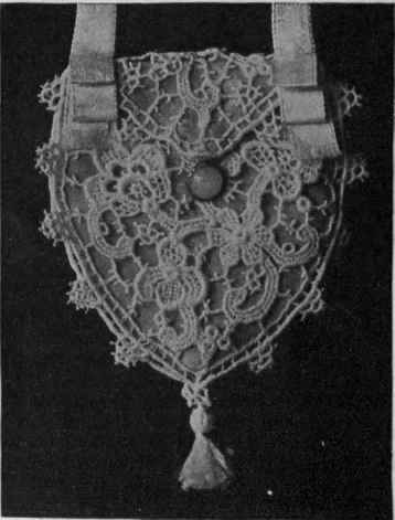 A dainty purse made of two medallions of guipure lace, lined