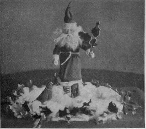 An idea for the centre of a Christmas party supper table. The presents are placed under cotton wool snow
