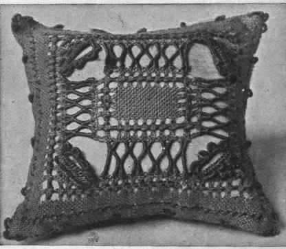 Blue linen pincushion worked with drawn thread and lace stitches