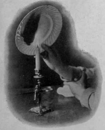 Fig. I. Holding the plate above the candle flame to smoke in the darkest part of the intended design.