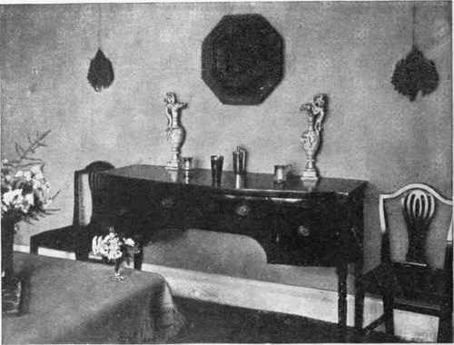 Furniture should never be crowded together. This Sheraton sideboard looks well because it is almost isolated