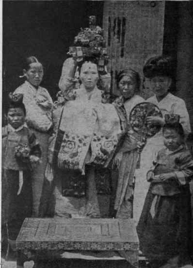 Sorcerers putting the crown of good luck on the head of the painted bride. A custom that prevails at Seoul, in Korea Photo, Underwood