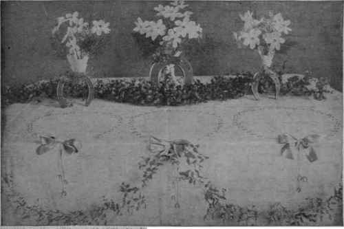 A novel Good Luck design for the buffet table at a March wedding. The flowers chosen are white narcissi in china vases.