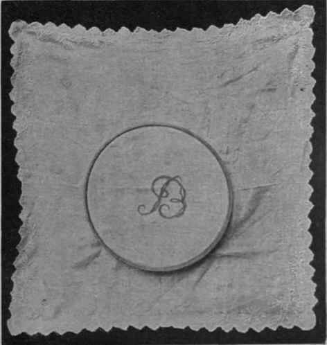 Cambric stretched on a drum frame seven inches in diameter in order to embroider initials