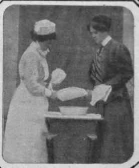 Fig. 2. Two people then wring the roller towel with the hot flannel inside