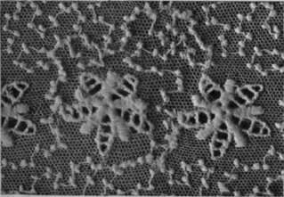 Fig. 4. The hole in the lace has been made good by this mode of mending, and the repair is practically invisible transfer the design to a fresh background, by pinning the pieces in