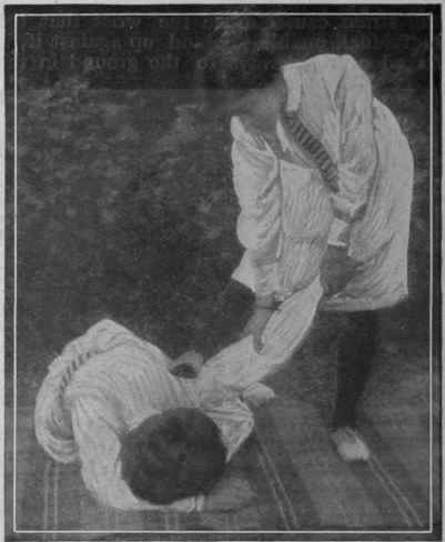 Fig. 4. The trick shown in Fig. 3 can be used to force the victim to the ground, by pressing on her shoulder with the right hand