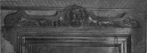 The enrichment of a door by the use of sections of old carved wood used as decoration