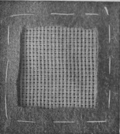 When the canvas has been tacked into position, the raw edges of the tear must be cut away to form an exact square
