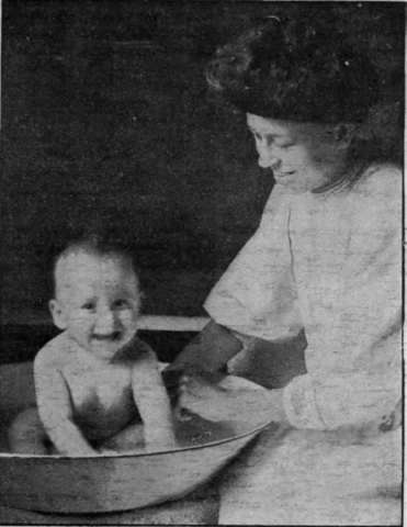 A baby enioys a tepid bath twice a day in hot weather, and shows his pleasure and delight