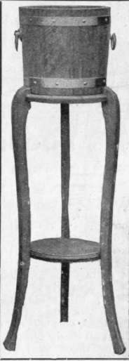 A wooden tub, bound with metal, on a stand of the same wood makes an inexpensive and excellent plant stand for a dining room