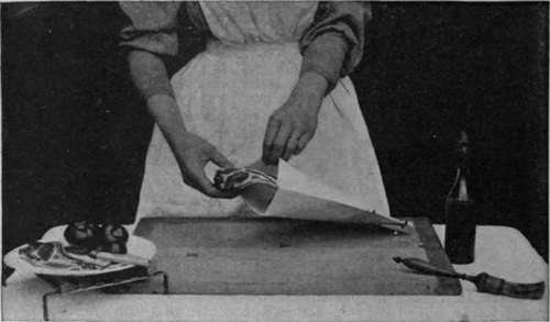 Putting a small joint of lamb into the paper bag