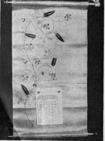 A calendar of white satin with a design of flowers, leaves, and berries, for which sequins, jewels, and beetles' wings are used
