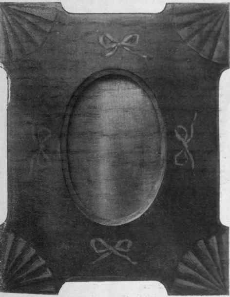 A photograph frame, the design of which is taken from the inlaid cabinet work of the Sheraton period