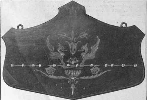 A pipe rack in marquetry. The design in the centre is effective and original