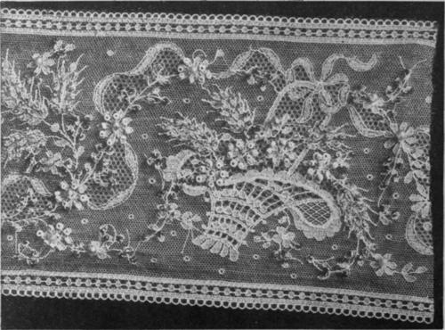 A ribbon design in lace is wonderfully improved by the addition of oat shaped beads. The flowers in the quaint basket show up to advantage when picked out in tiny beads