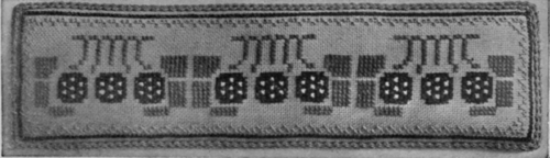 A useful pincushion in cross stitch, with a conventional design of roses, and a plain edging of green silk gimp