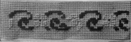 An easily worked and effective pattern for a dress trimming in canvas and cross stitch