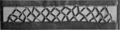 An entre deux of bugles and round glass beads between two strips of velvet ribbon. This is an effective and quickly worked pattern, and can be contrived in any width desired