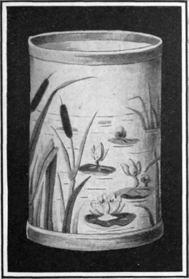 Another application of the designs for German applique is suggested as a decoration for a wastepaper basket