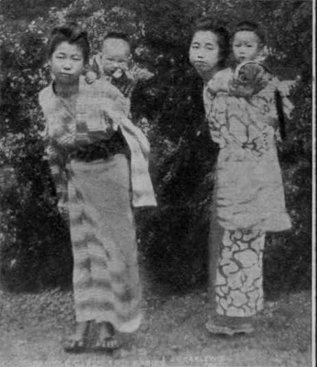 Little Japanese girls with their brothers on their backs