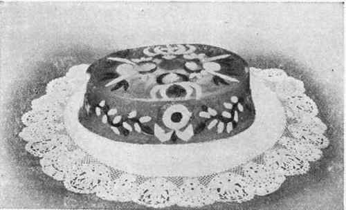 Capon in Aspic garnished with cooked yolks and whites of eggs cut in fancy shapes, pistachio nuts, and truffles.