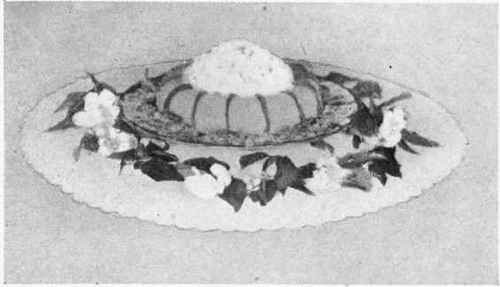 Orange Trifle garnished with Whipped Cream, Candied Orange Peel, and Blossoms.
