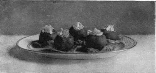 Tomatoes Stuffed With Celery And Mayonnaise Standing On Lettuce Leaves.