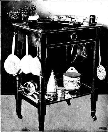 A Two Story Kitchen Table On Rollers