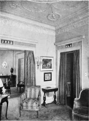 AN ADAM ROOM WITH PLASTER WALLS, OVERDOOR DECORATIONS, AND CLASSICALLY DESIGNED CORNICE AND CEILING.