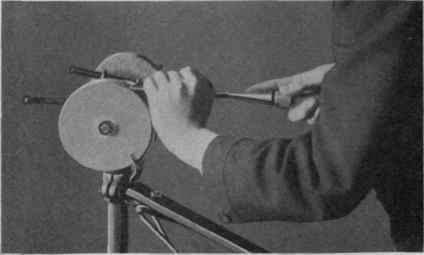 Fig. 21. Grinding a Chisel.
