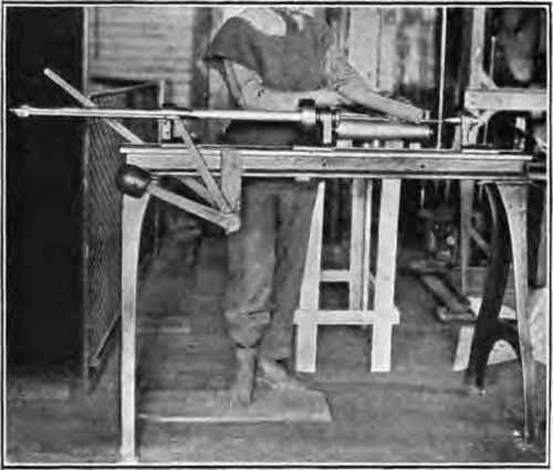 Case rolling machine; removing case from machine.